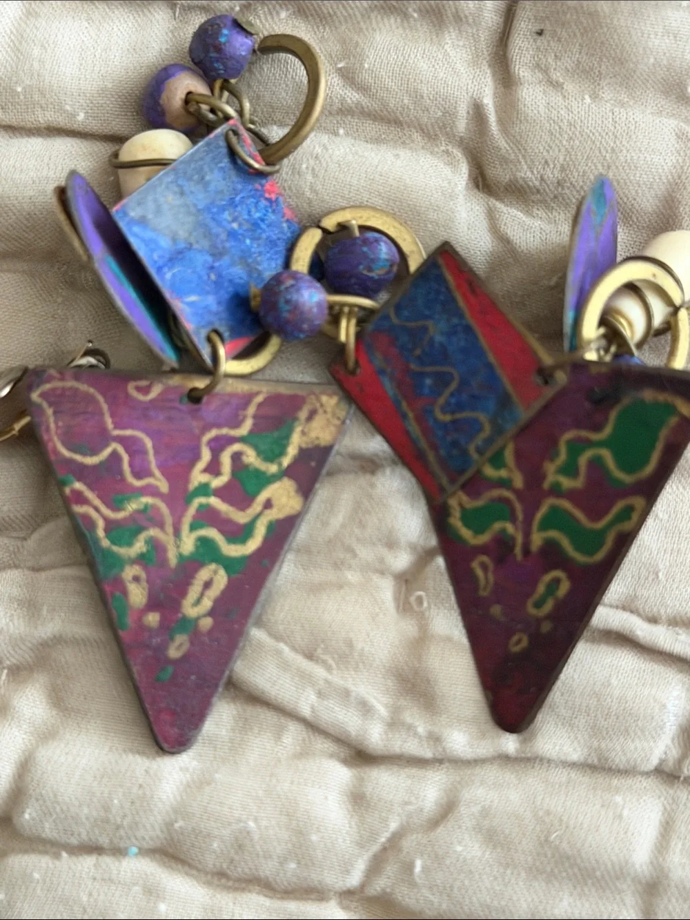 Clip style earrings artist made abstract metal pieces with attached panels